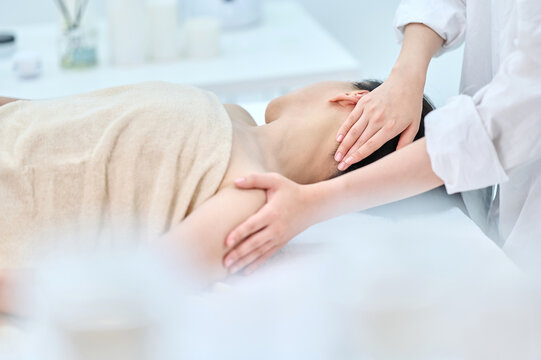 Female Neck and Shoulder Massage Therapy for Relaxation at Spa