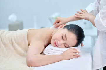 Female Gua Sha Back and Shoulder Massage Therapy with Oil at Spa