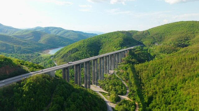 Tall bridge with green valley and traffic