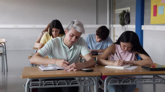 Students writing and studying in classroom