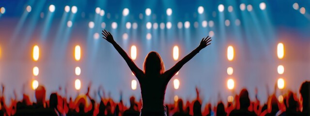 Audience Celebrates With Hands Raised at a Lively Concert During the Evening