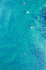 drone shot looking down on fishing boats in clear water.Top down drone view