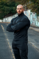 Muscular man in sportswear outdoor. Athletic male outside