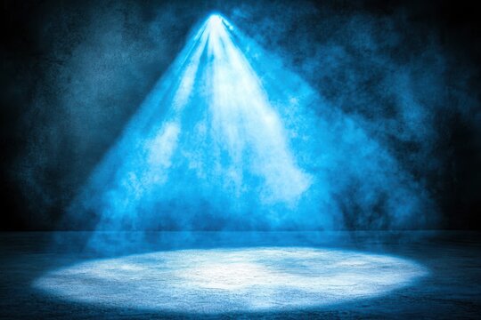 A stage with blue light rays shining down on a dark background, emphasizing the main subject and theme of the image.