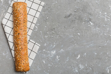 fresh crunchy french baguette on colored table. Top view Bakery products