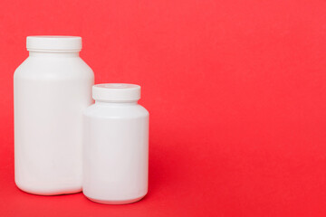 supplement pills with medicine bottle health care and medical top view. Vitamin tablets. Top view mockup bottle for pills and vitamins with green leaves, natural organic bio supplement, copy space