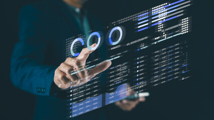 A person interacts with a futuristic digital dashboard displaying analytics, graphs, and data visualizations.