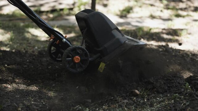 Land cultivation with an electric cultivator.