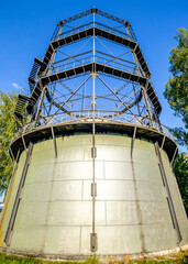 Industrial gas tank structure under a gray sky showcasing modern architecture and engineering at a construction site