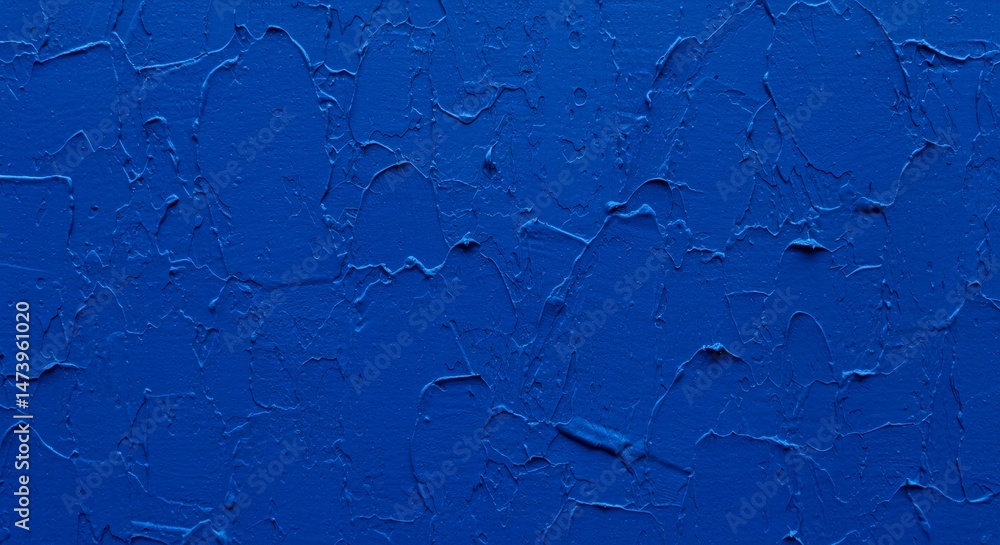 Poster close-up of textured vibrant blue paint on a canvas with visible brushstrokes and a rough, uneven su