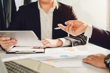 Business leaders collaborate in a strategy meeting analyzing green data graphs and discussing sustainable solutions through teamwork, technology and mutual agreement.