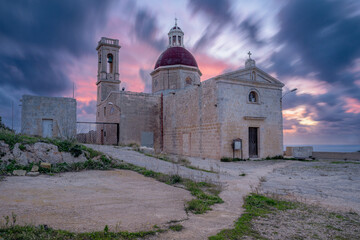 Historic Church With Dome and Bell Tower Under Dramatic Twilight Sky