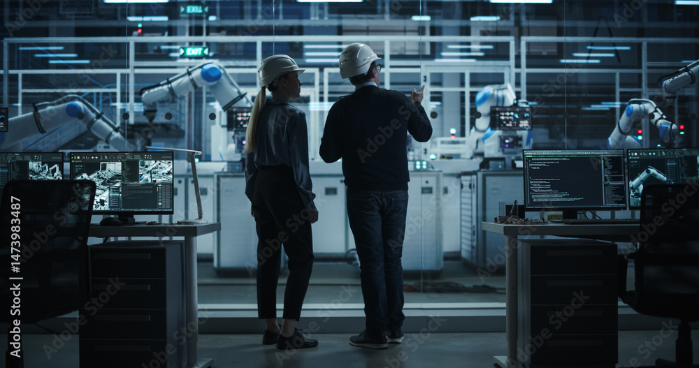Aufkleber Female and Male Industrial Engineers Having a Conversation at a Modern Tech Electronics Factory with Automated Robot Arms Working with the Help of Artificial Intelligence Software. Back View