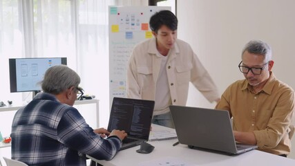 Asian senior bootcamp team asking and  learning programming with software training and whiteboard collaboration