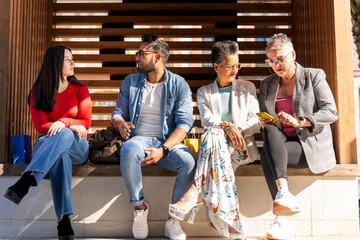 Fototapeta premium Group of diverse friends relaxing together after shopping spree