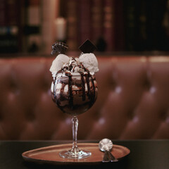 Dark Chocolate Parfait. Midnight chocolate served with vanilla ice cream and topping with whipping cream and popcorn. Vintage film grained filter.