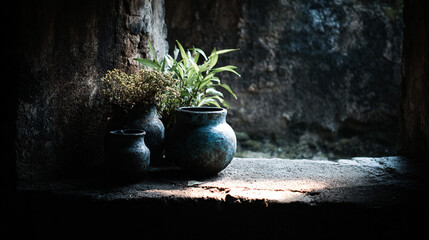 Ancient metal vessels in a rustic stone niche.