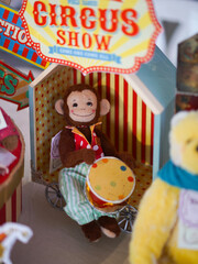 Cute Monkey Doll. A closed up of a happy monkey doll is sitting among his circus friends in colorful circus theme concept. Doll's display during the weekend doll market.