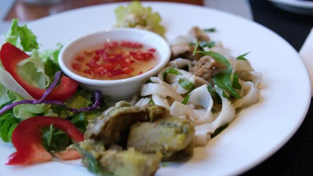 rice vermicelli with soy salad and chili fish sauce vietnamese asian food on white plate