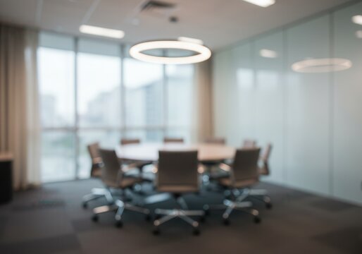 Blurred view of a modern conference room with a round table and chairs in a corporate office