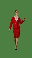 Elegant Flight Attendant in Red Uniform on Green Background
