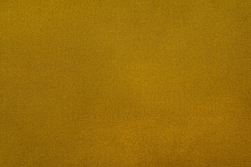 The image features a detailed view of a golden-yellow fabric's interesting woven texture in an artistic display.