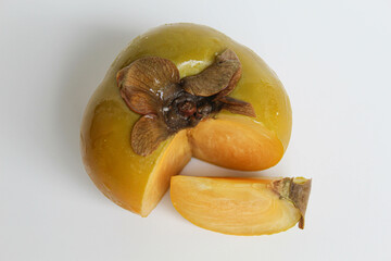 Cut flesh persimmon fruit, isolated on white background