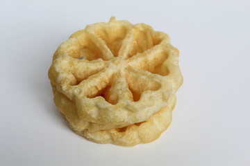 Kembang goyang cake, traditional snack from Indonesia. Fried dough in wheel or flower shaped. Isolated on white backgroun