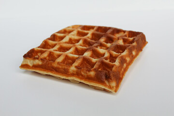 One plain square waffle cake, burnt side, isolated on white background