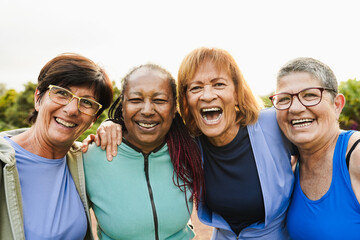 Happy senior women having fun after yoga session outdoor at city park - Healthy joyful elderly...