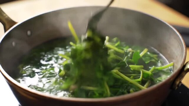 Fresh Spinach Plunging Into Boiling Water In Slow Motion Close Up