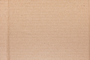 Authentic brown corrugated cardboard with natural fiber accents, textured recycled carton paper.