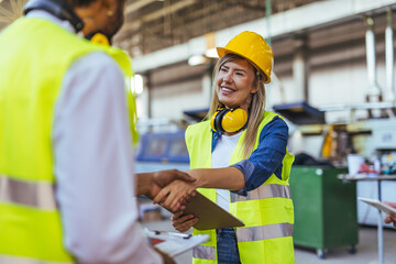 Female Construction Worker Shaking Hands in a Manufacturing Facility