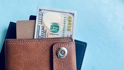 leather wallet with hundred dollar bills and credit cards on blue background, modern finance, money...