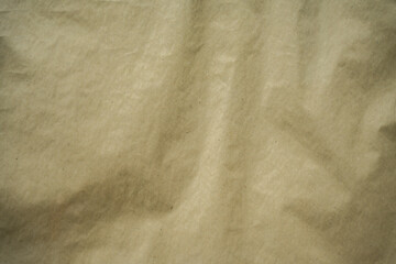 Textured close-up of crumpled brown recycled paper. Ideal as a background, texture, or design surface.