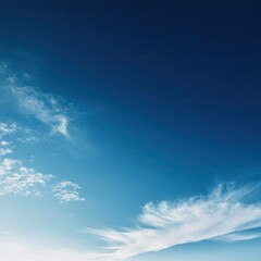 Vast blue sky with soft white clouds