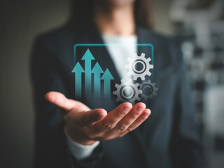 Businesswoman presenting growth arrows and gears on hand for performance and strategy