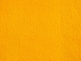 Yellow cement background summer wallpaper banner, plaster stucco wall floor backdrop.