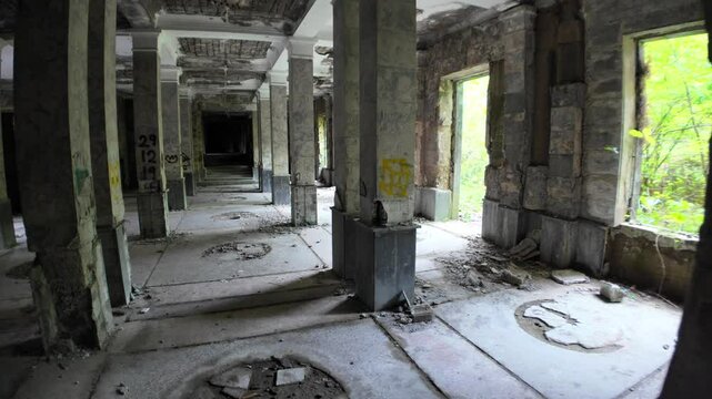 Sunlight streaming through a broken window highlights the decaying grandeur of Sanatorium Medea in Tskaltubo, Georgia, a haunting relic of the Soviet era