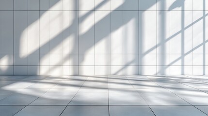 Obraz premium Sunlight casts shadows on a clean, tiled space