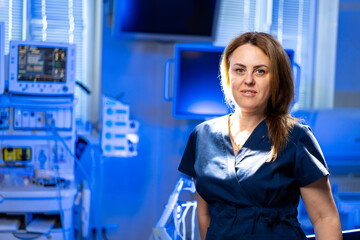 Healthcare worker in a clinic. A healthcare worker in scrubs stands confidently in a modern medical...