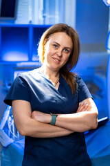 Confident doctor in clinic. A healthcare worker stands with arms crossed in a well-lit medical...