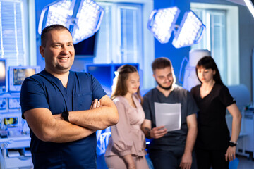 Clinic team talks patient care. A healthcare professional smiles while colleagues review patient...