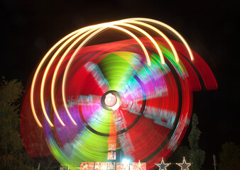 Captivating long exposure shot of amusement ride lights