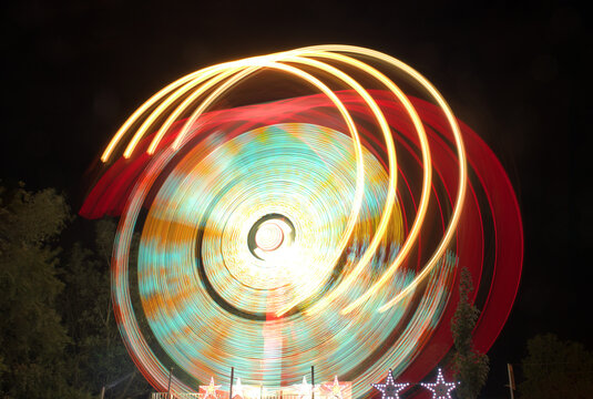 Captivating long exposure of colorful amusement park ride