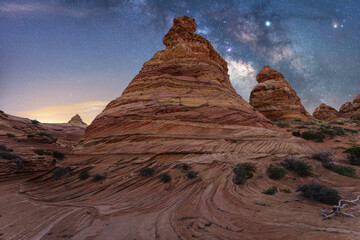 Majestic rock formations under a starry night sky in Coyote Buttes