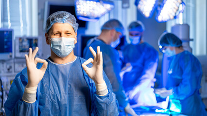 Surgeon gets ready for surgery. Surgeon in scrubs communicates readiness before a surgical...