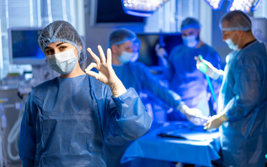 Surgeons succeed in surgery. Healthcare professionals in surgical attire showcase teamwork and...