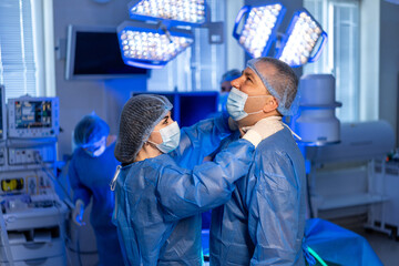 Surgery prep by medical team. A medical team works diligently in a surgical room, preparing for an...