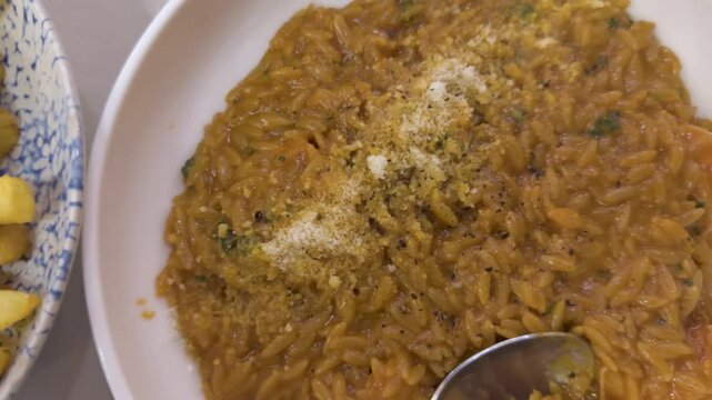 Overhead pan from savory orzo dish to crispy fries served with a fried egg on top.